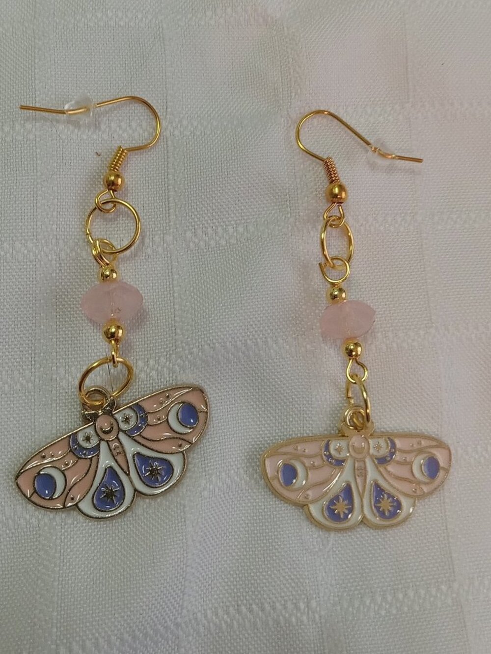 Handmade gold-colored earrings with multicolored enameled butterflies and beads